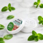 تصویر تصویر جعبه و پودر سفید کننده دندان پیوریتی پلاس با طعم نعناع (Mint) و برگ‌های تازه نعناع